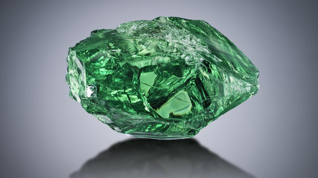 This rough tsavorite crystal was mined near Merelani, Tanzania, and weighed more than 283 carats before being shaped into the 177-facet, nearly 117 carat Lion of Merelani. 20230419_Tsavorite rough.jpg